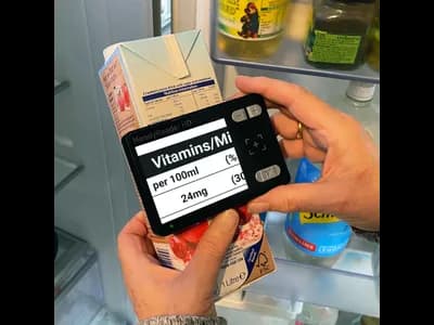 HandyReader HD portable magnifier, magnifying the side of a cranberry juice carton.